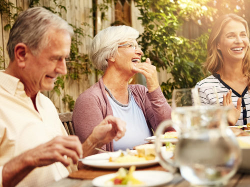 Shot of a family eating lunch together outdoors