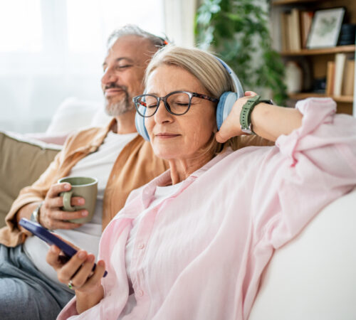 Relaxed mature couple together listening to music at home